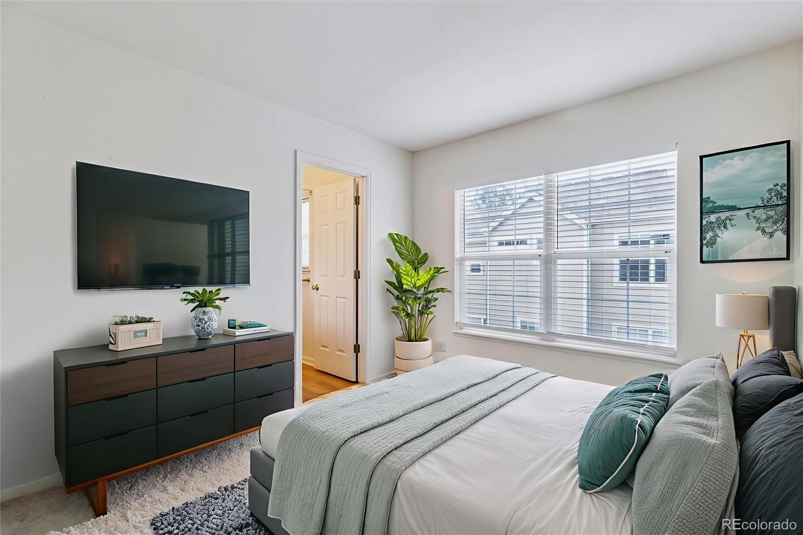 260 West Jamison Circle, Unit 13 Littleton, CO 80120 - Photo 16 of 24 a bedroom with a bed and a flat screen tv