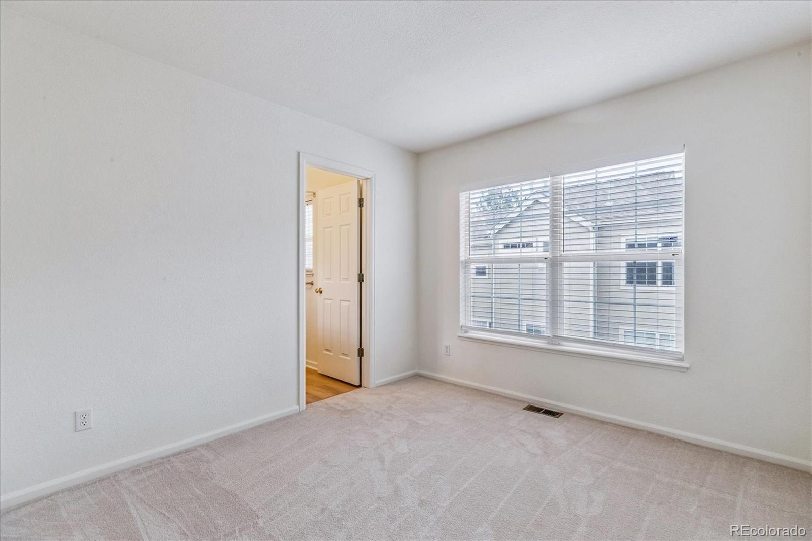 260 West Jamison Circle, Unit 13 Littleton, CO 80120 - Photo 17 of 24 a view of an empty room with a window