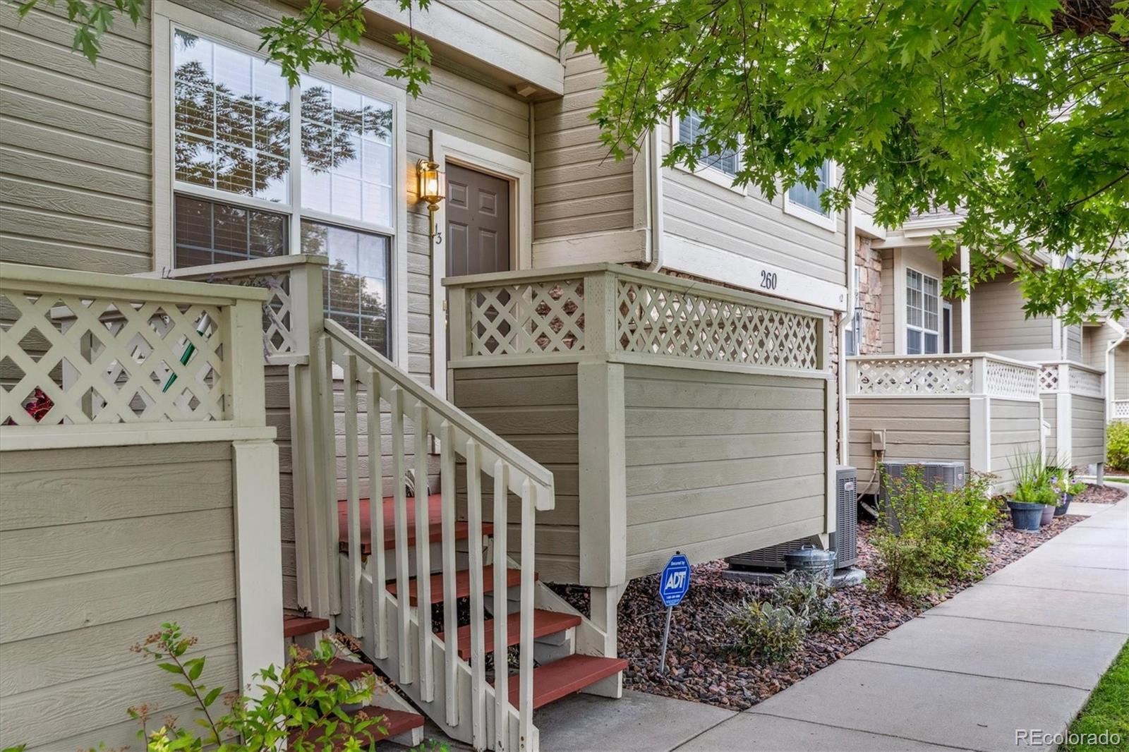 260 West Jamison Circle, Unit 13 Littleton, CO 80120 - Photo 22 of 24 a view of a house with a small yard and potted plants