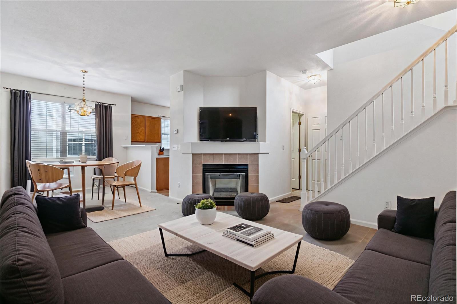 260 West Jamison Circle, Unit 13 Littleton, CO 80120 - Photo 3 of 24 a living room with furniture a fireplace and a flat screen tv