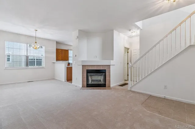a view of a livingroom with a fireplace and window