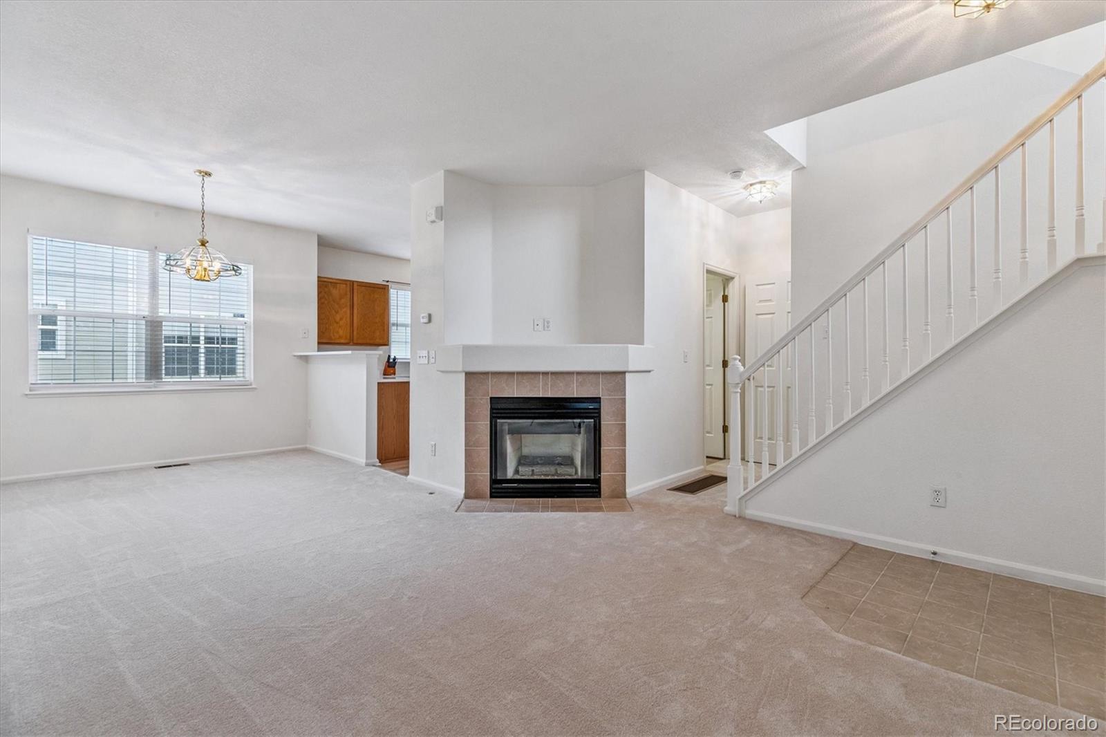 260 West Jamison Circle, Unit 13 Littleton, CO 80120 - Photo 4 of 24 a view of a livingroom with a fireplace and window