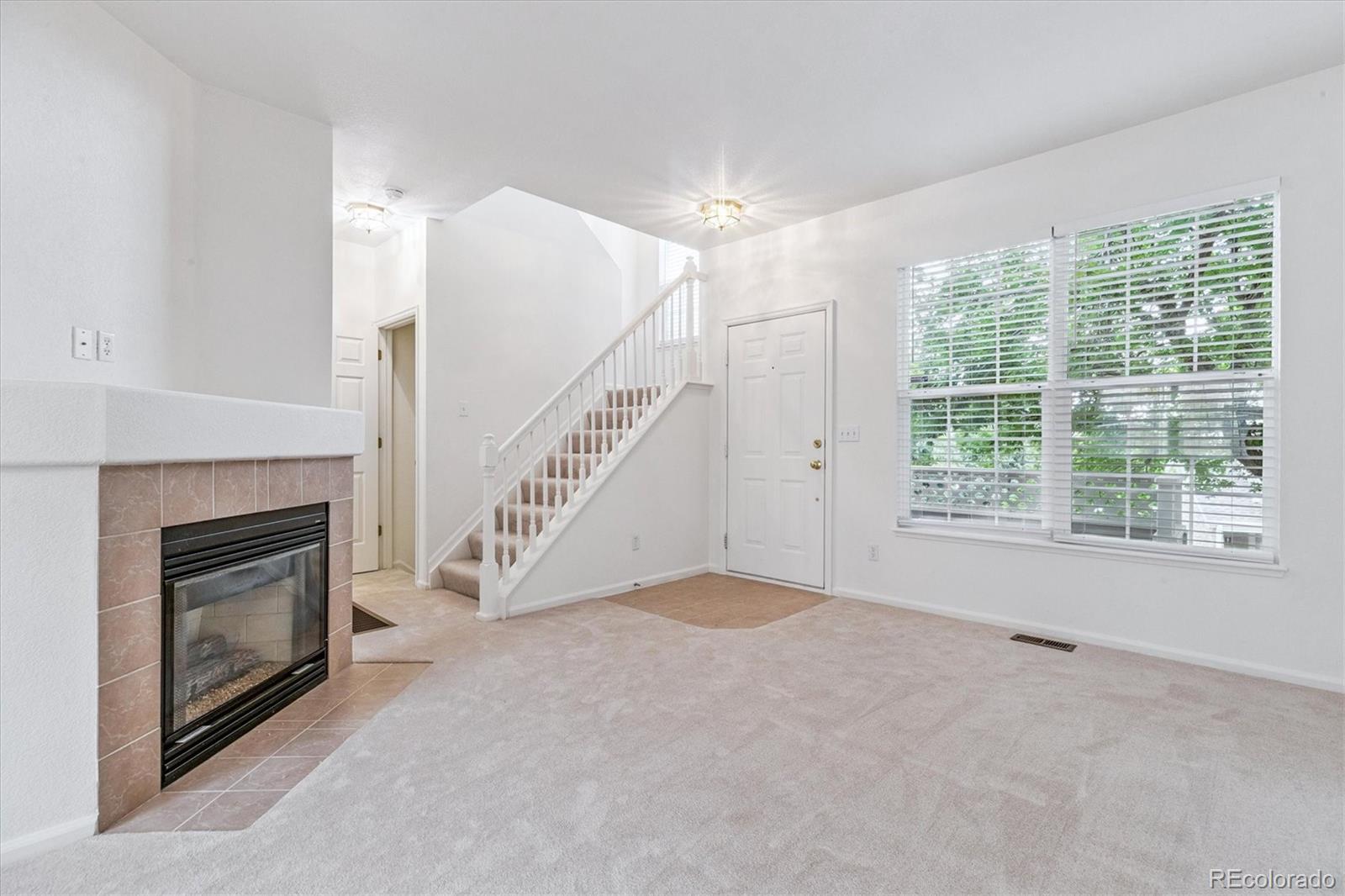 260 West Jamison Circle, Unit 13 Littleton, CO 80120 - Photo 6 of 24 a view of empty room with fireplace and windows