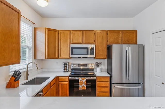 a kitchen with a refrigerator and a sink