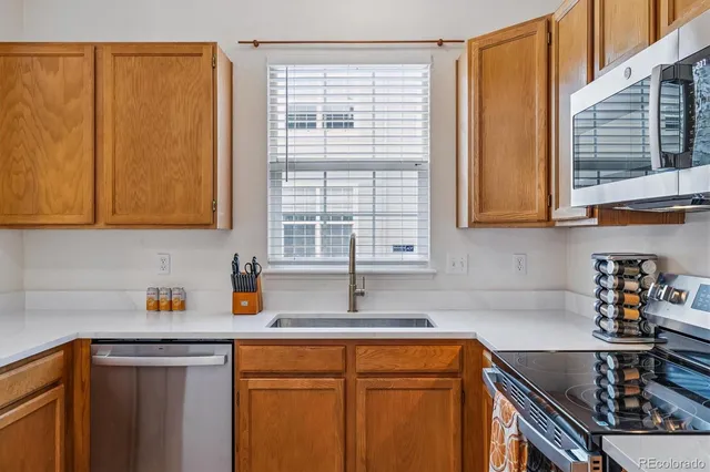 a kitchen with stainless steel appliances granite countertop a sink and a cabinets