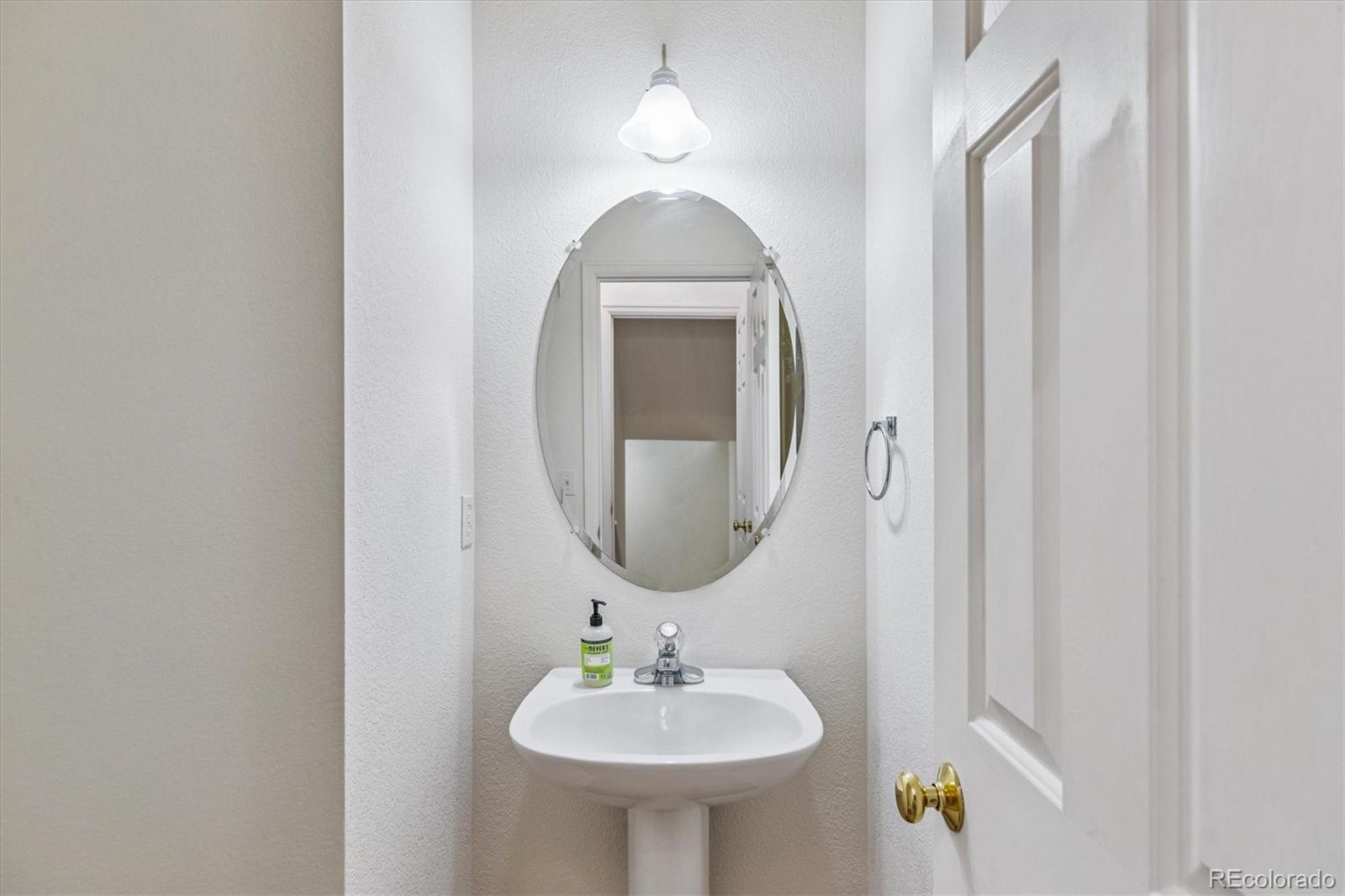260 West Jamison Circle, Unit 13 Littleton, CO 80120 - Photo 10 of 24 a bathroom with a sink and a mirror