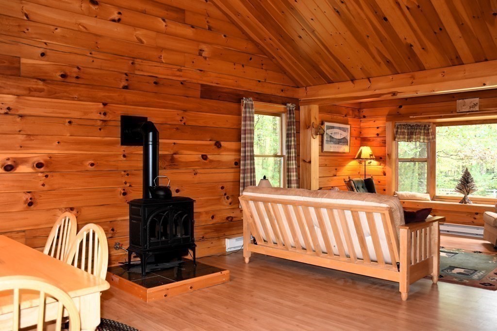 145 Baker Pond Road Dudley, MA 01571 - Photo 15 of 27 a view of a porch with furniture and wooden floor