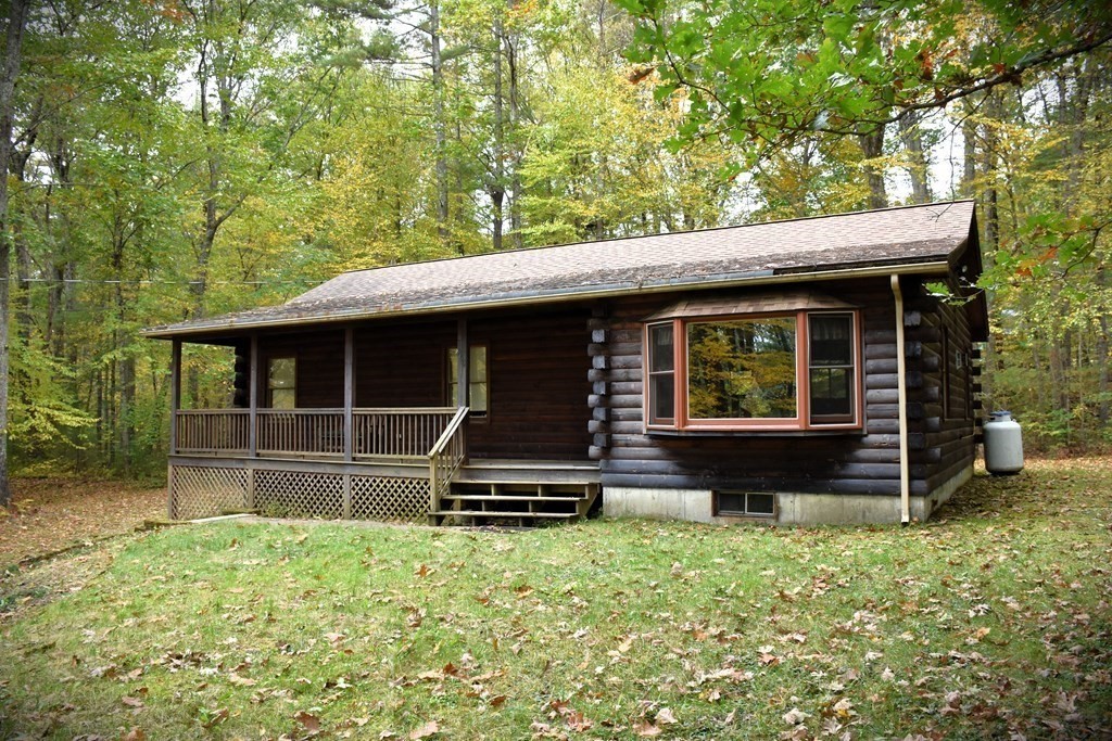 145 Baker Pond Road Dudley, MA 01571 - Photo 2 of 27 a view of house with backyard outdoor seating and green space