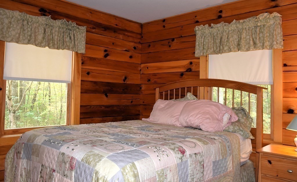 145 Baker Pond Road Dudley, MA 01571 - Photo 22 of 27 a bedroom with a bed and a window