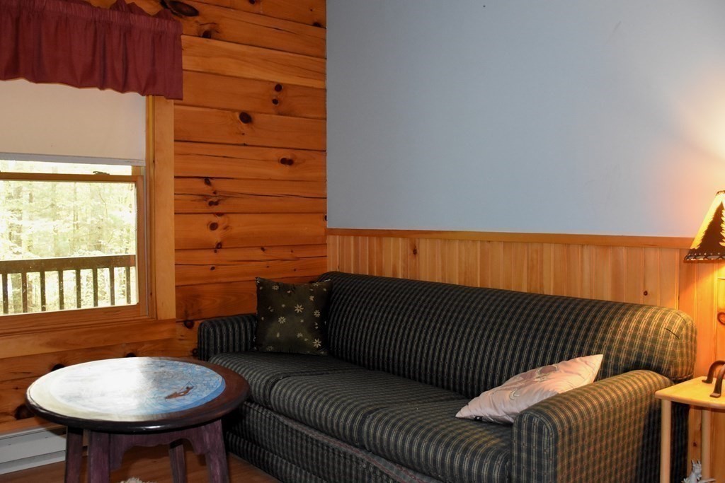 145 Baker Pond Road Dudley, MA 01571 - Photo 26 of 27 a balcony with a table and chairs