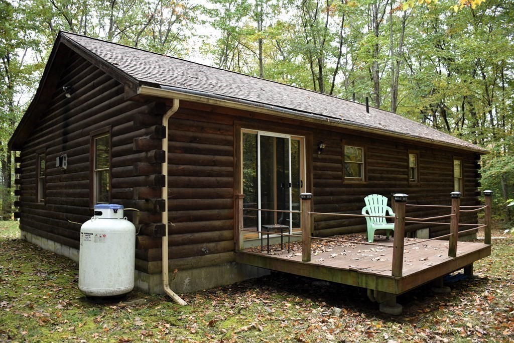 145 Baker Pond Road Dudley, MA 01571 - Photo 3 of 27 a view of a chair and table on the deck