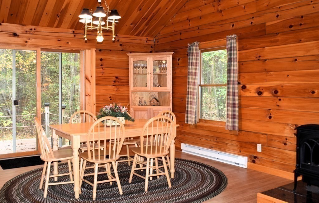 145 Baker Pond Road Dudley, MA 01571 - Photo 7 of 27 a dining room with furniture a chandelier and wooden floor