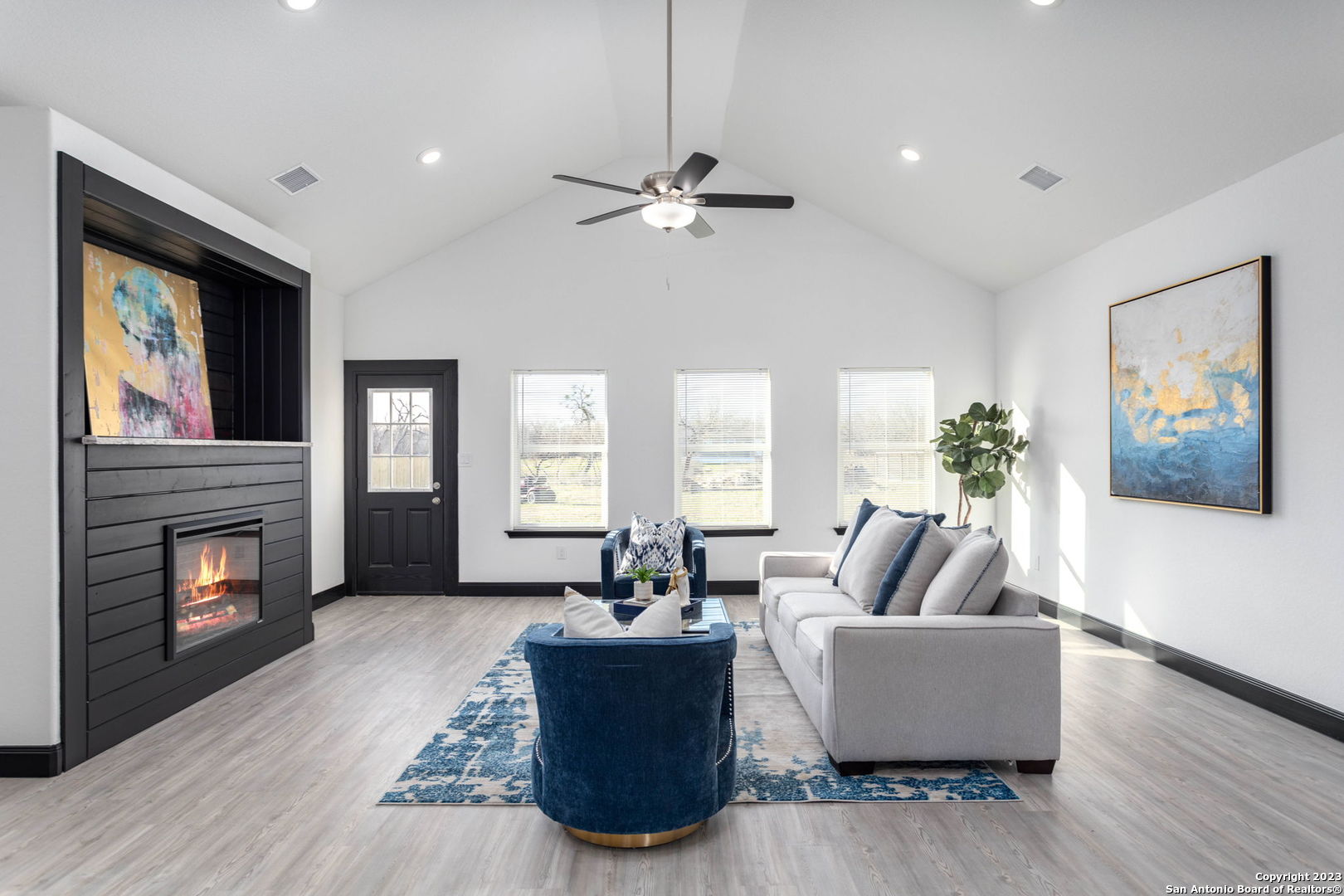 a living room with furniture fireplace and window