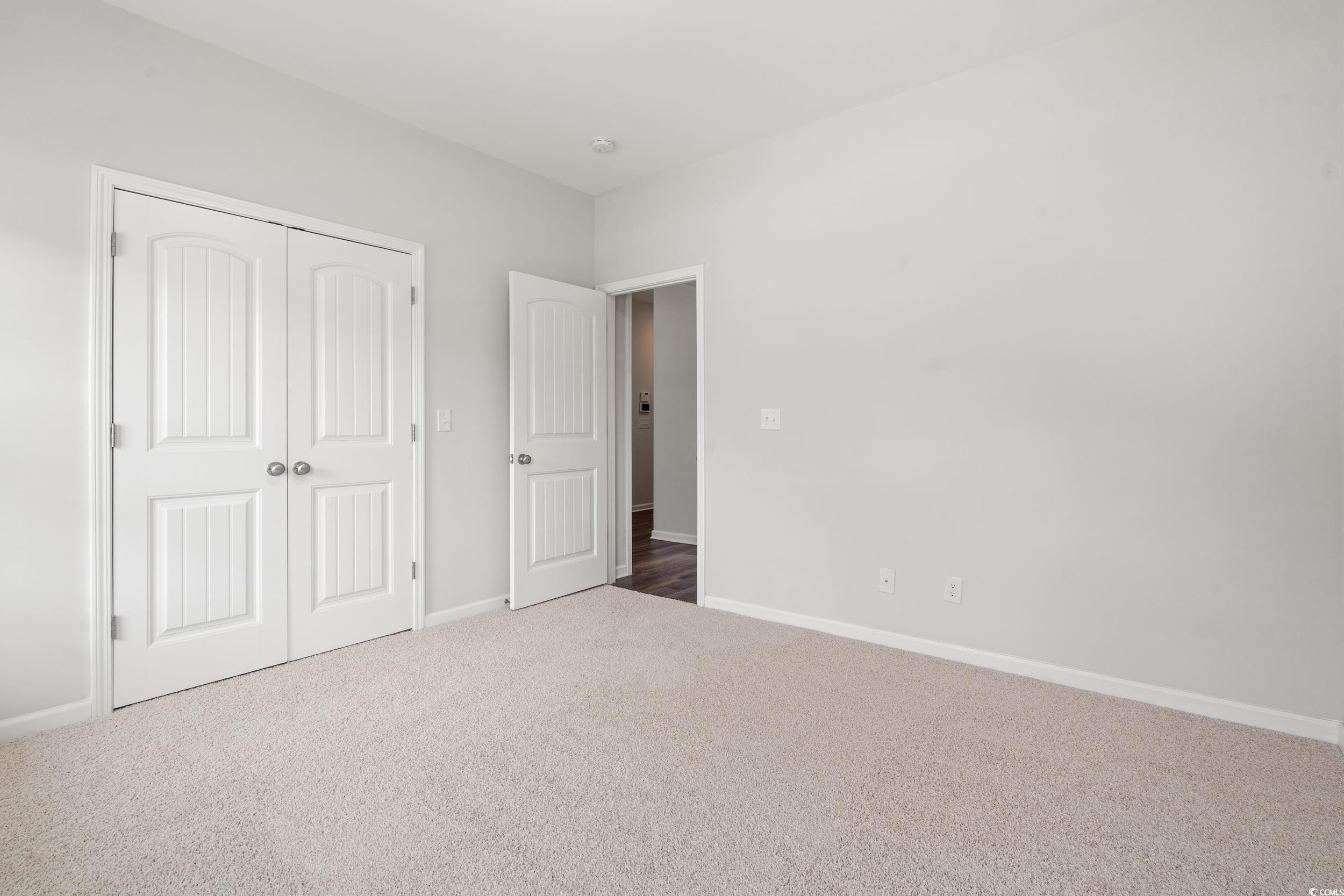 512 Charlton Boulevard Georgetown, SC 29440 - Photo 12 of 35 Unfurnished bedroom with carpet flooring, baseboards, and a closet