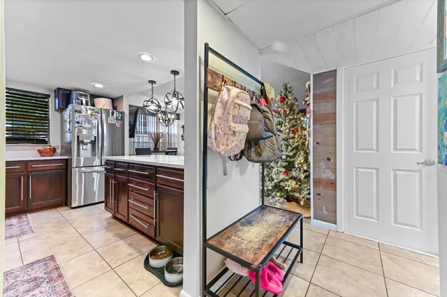 a kitchen with stainless steel appliances granite countertop a refrigerator and a stove