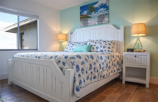 a bedroom with a bed and a lamp