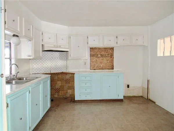 a kitchen with cabinets oven a sink and dishwasher