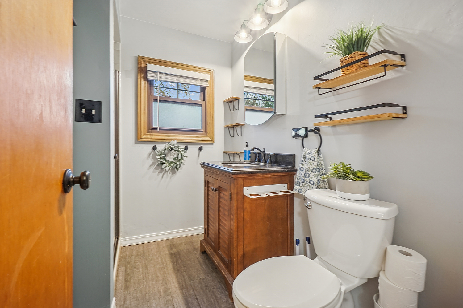 14317 Kilbourn Avenue Midlothian, IL 60445 - Photo 11 of 17 a white toilet sitting next to a bathroom sink and vanity
