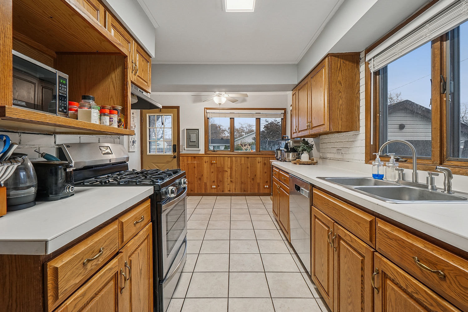 14317 Kilbourn Avenue Midlothian, IL 60445 - Photo 4 of 17 a kitchen with stainless steel appliances a sink stove and cabinets