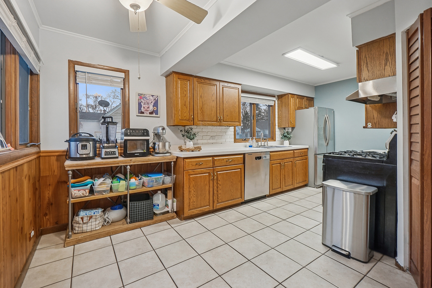 14317 Kilbourn Avenue Midlothian, IL 60445 - Photo 5 of 17 a kitchen with a sink and a stove top oven