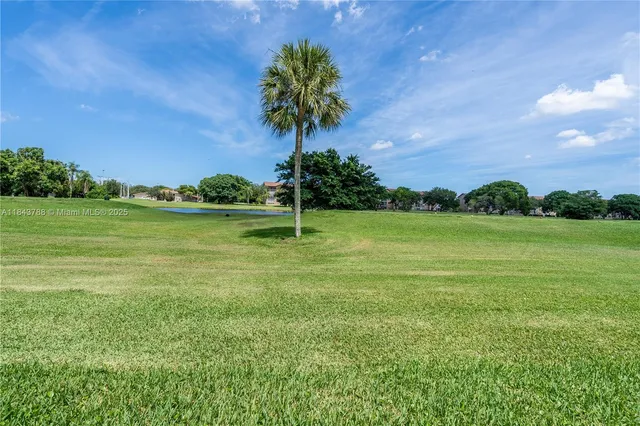 a view of a garden with a building in the background