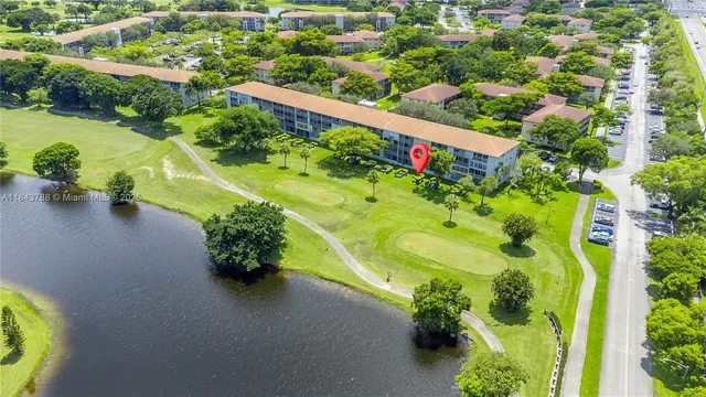 an aerial view of a residential houses with yard
