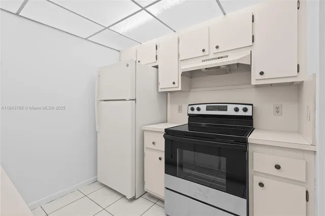 a kitchen with cabinets and steel stainless steel appliances