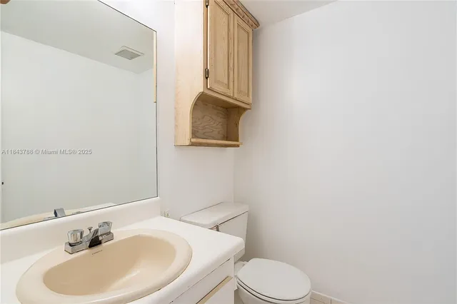 a bathroom with a sink a toilet and mirror