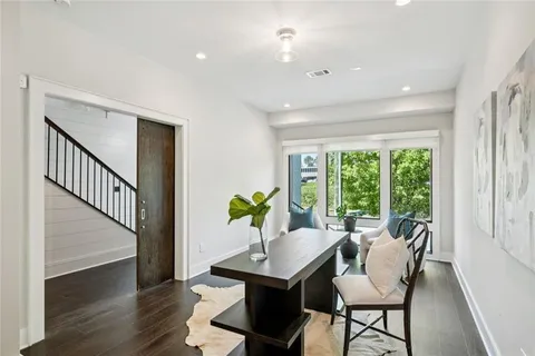 a kitchen that has a lot of cabinets in it and wooden floors