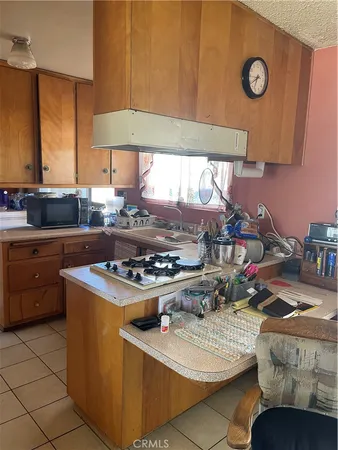 a kitchen with stainless steel appliances granite countertop a stove a sink dishwasher and cabinets with wooden floor
