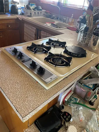 a stove top oven sitting inside of a kitchen