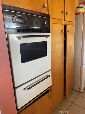 a stove top oven sitting inside of a kitchen