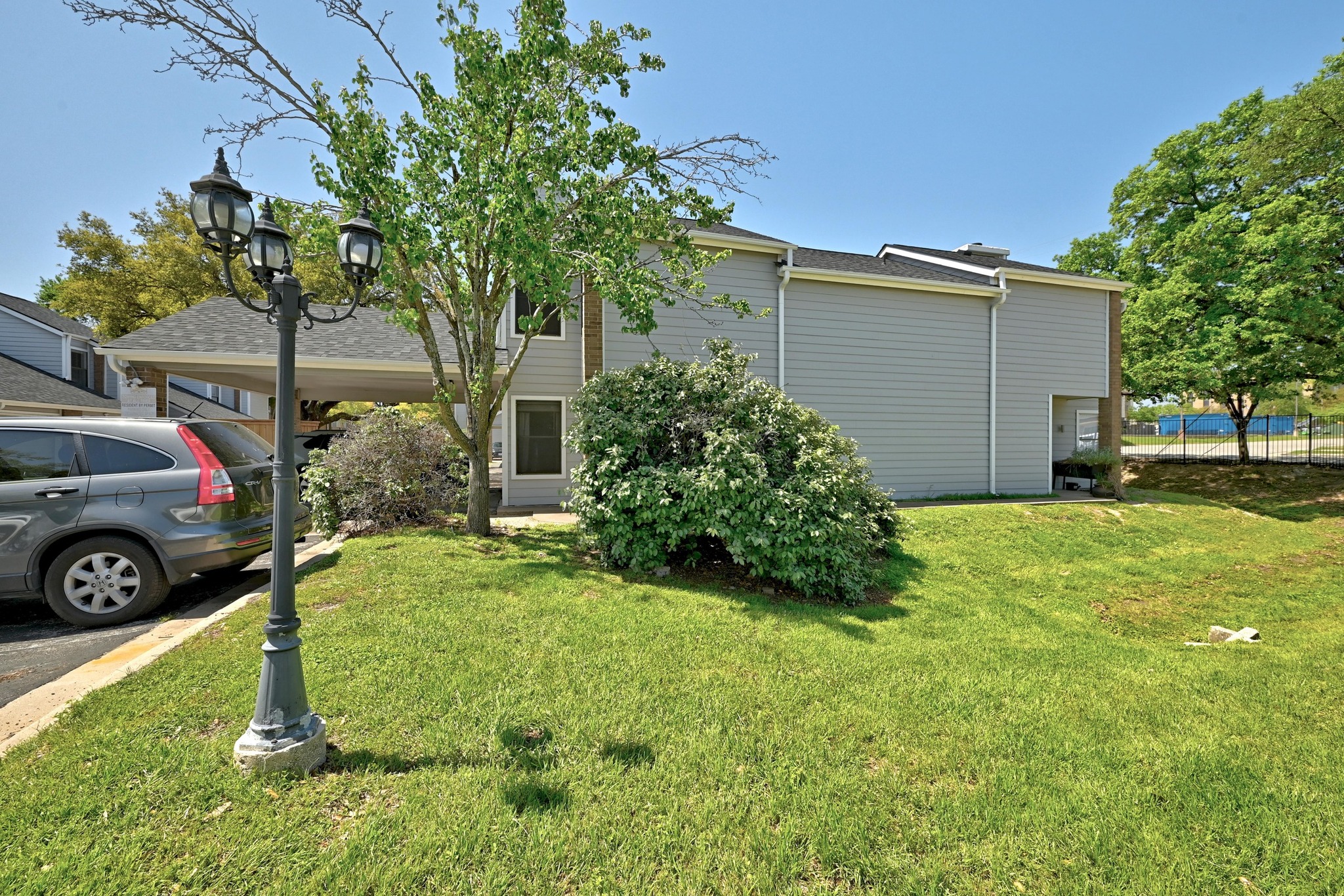 7635 Guadalupe Street, Unit 1002 Austin, TX 78752 - Photo 25 of 27 a view of a backyard with a car parked in it