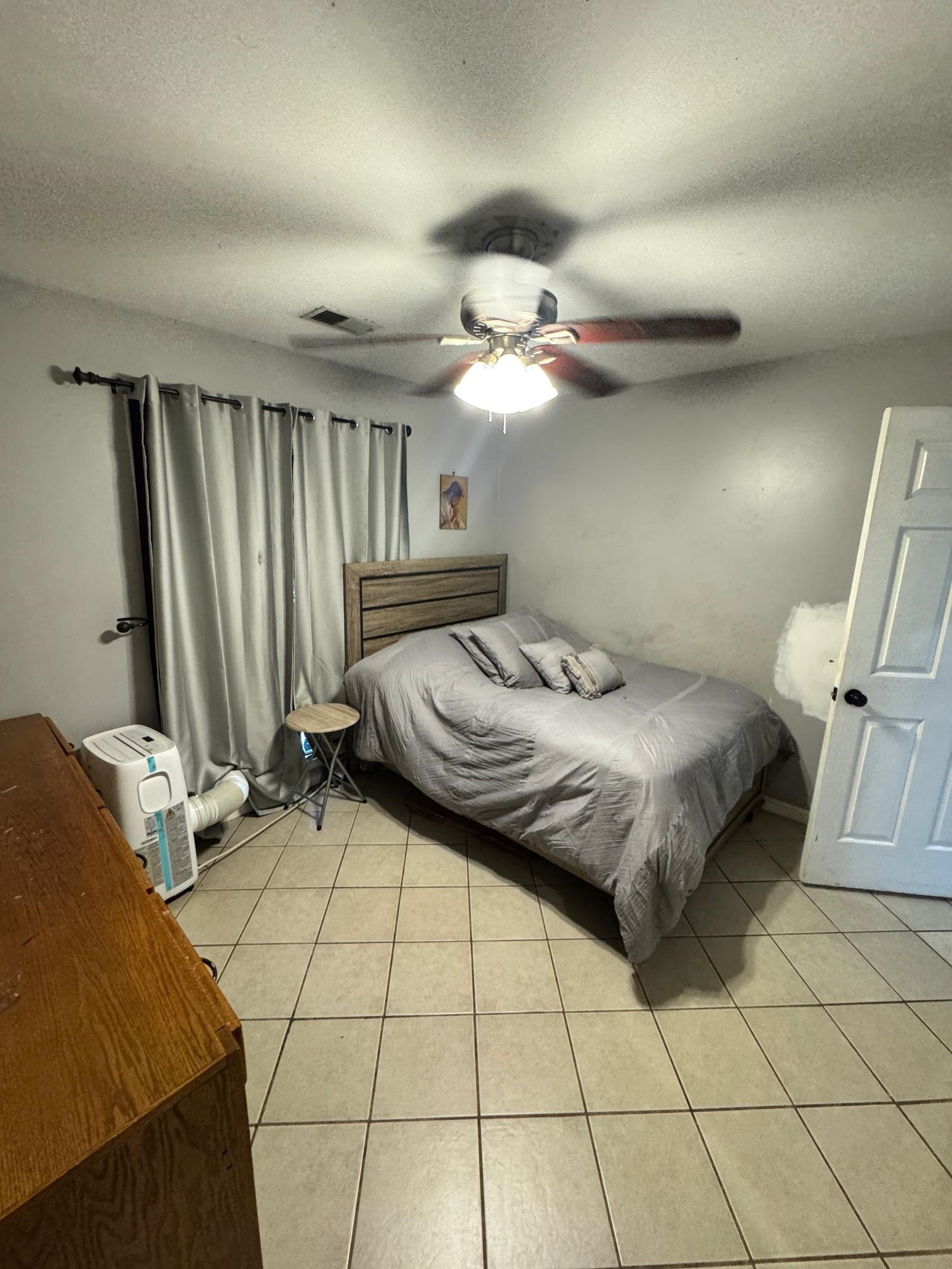 4709 Valene Circle Memphis, TN 38141 - Photo 15 of 23 a bedroom with a bed and a chandelier