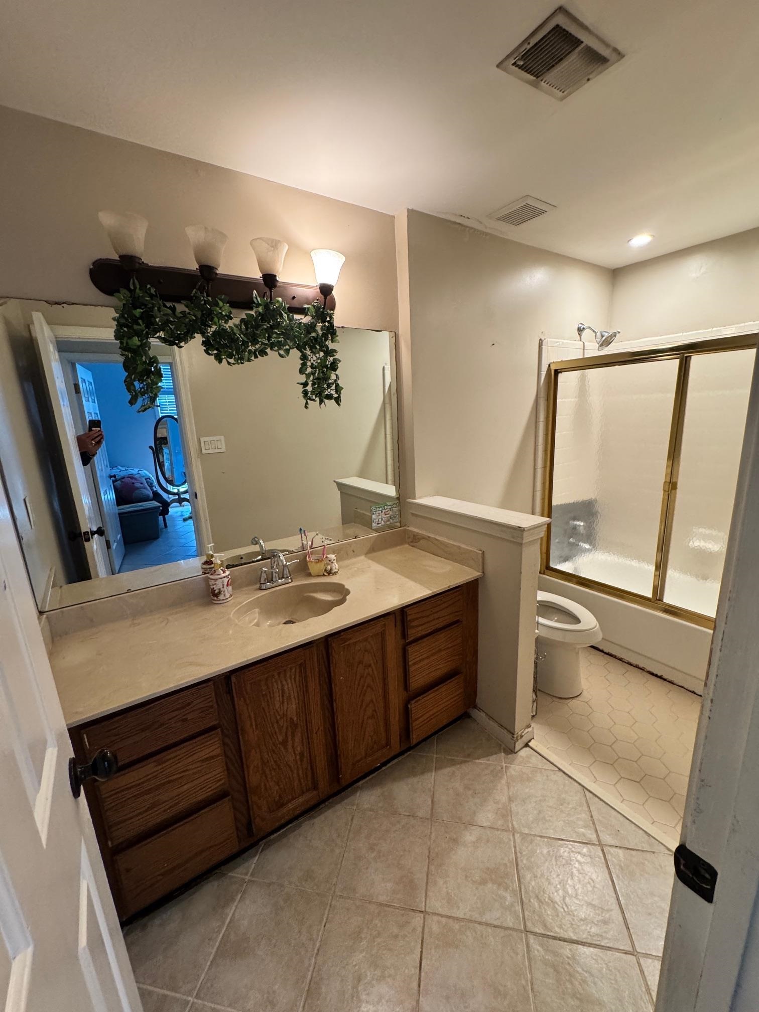 4709 Valene Circle Memphis, TN 38141 - Photo 19 of 23 a bathroom with a tub sink and a mirror