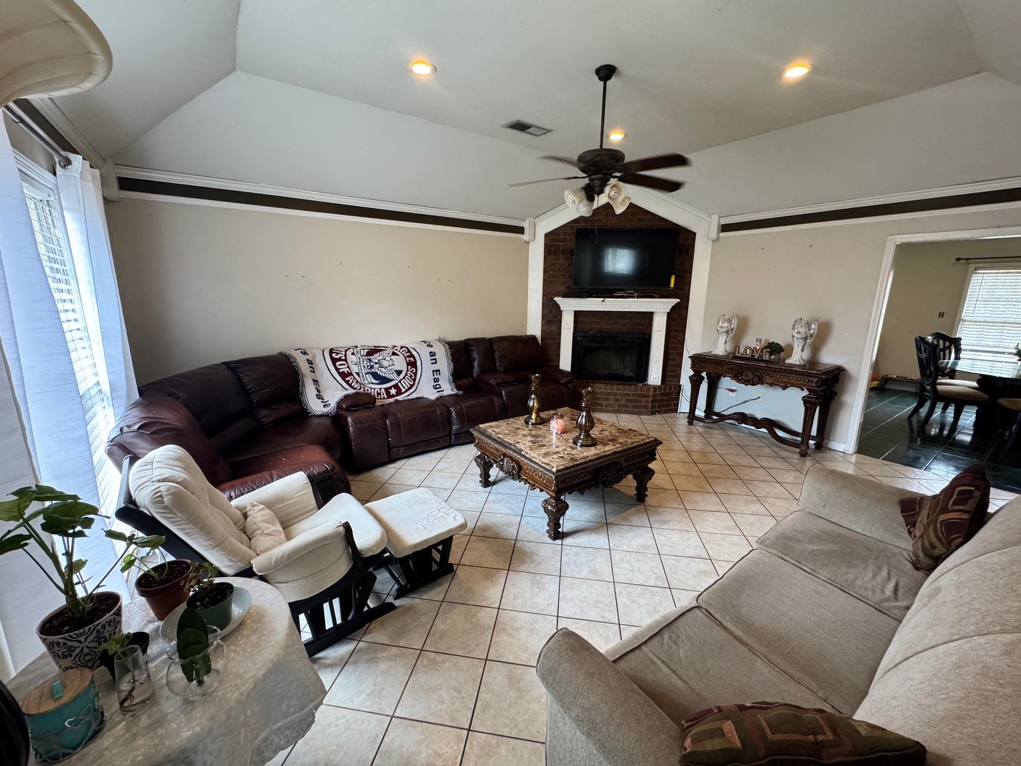 4709 Valene Circle Memphis, TN 38141 - Photo 3 of 23 a living room with furniture a fireplace and a chandelier