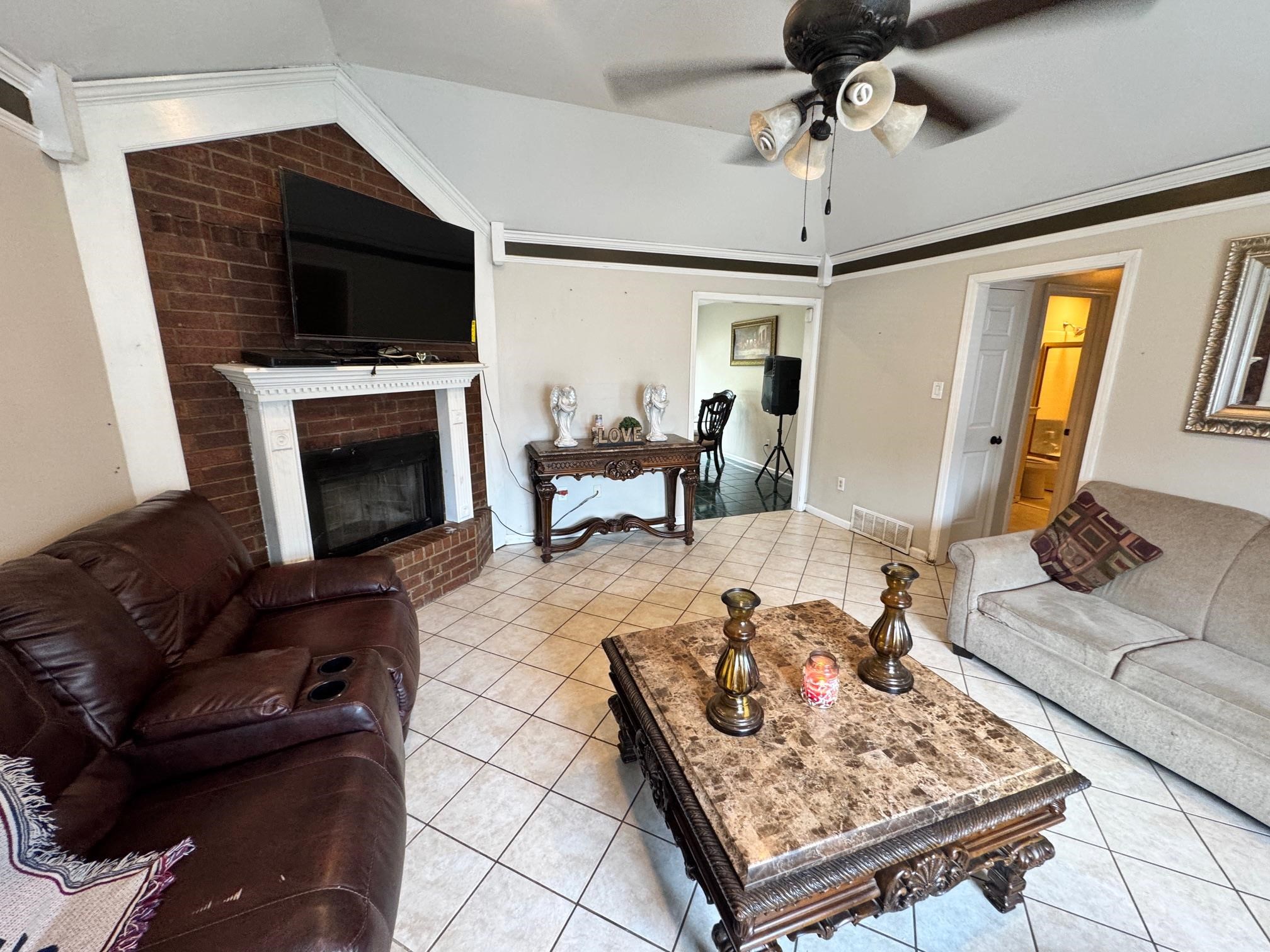 4709 Valene Circle Memphis, TN 38141 - Photo 6 of 23 a living room with furniture and a fireplace