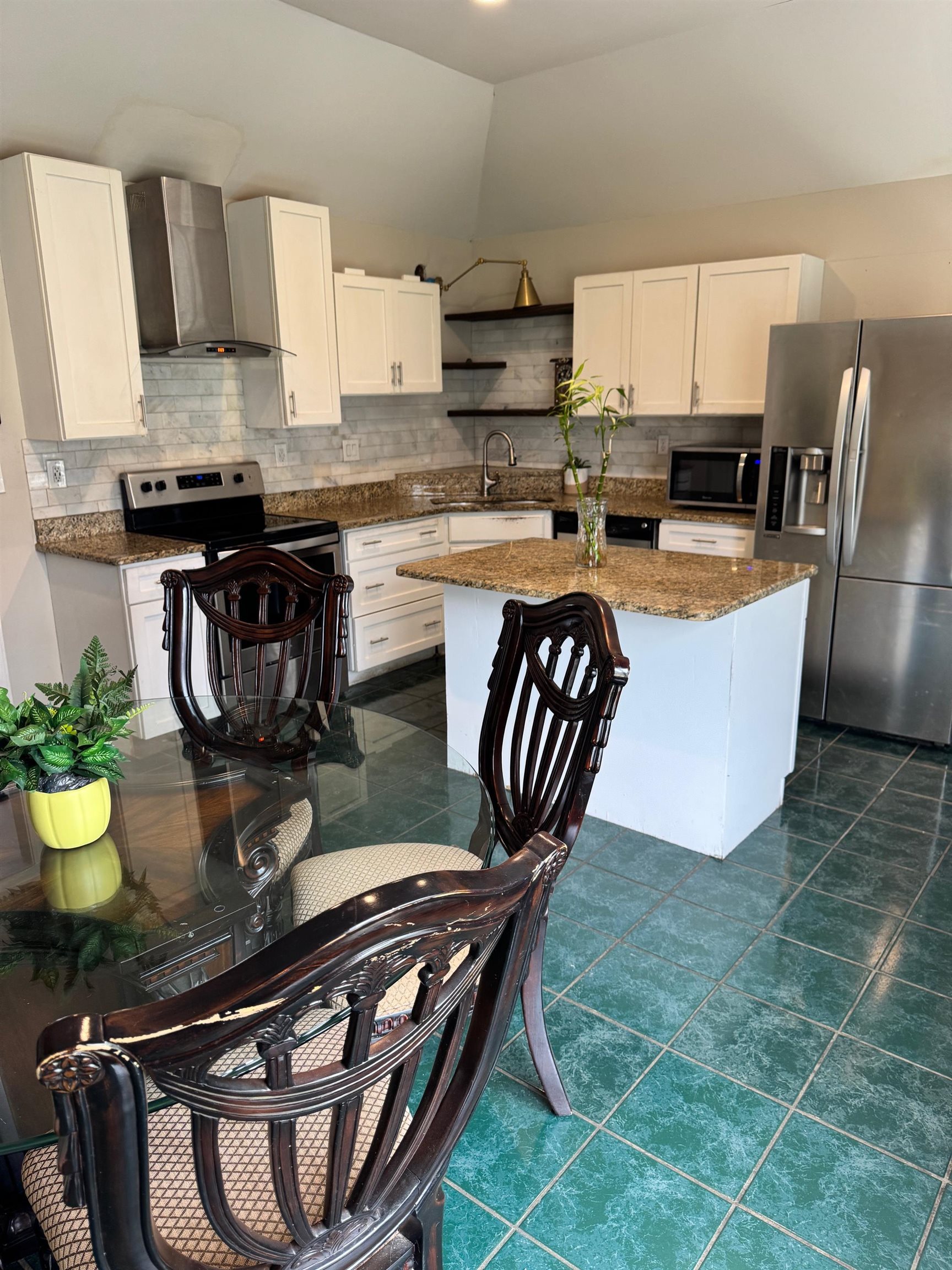 4709 Valene Circle Memphis, TN 38141 - Photo 8 of 23 a kitchen with stainless steel appliances granite countertop a stove a refrigerator and a dining table