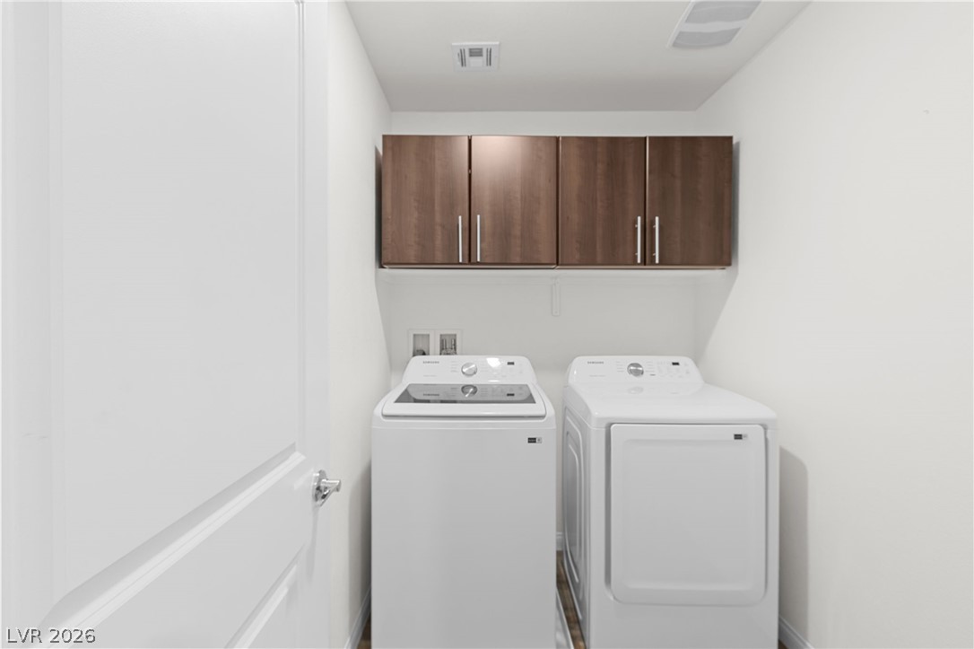 12367 Indigo Montage Road, Unit 3 Las Vegas, NV 89183 - Photo 20 of 33 This dedicated laundry space combines modern convenience with smart storage solutions.