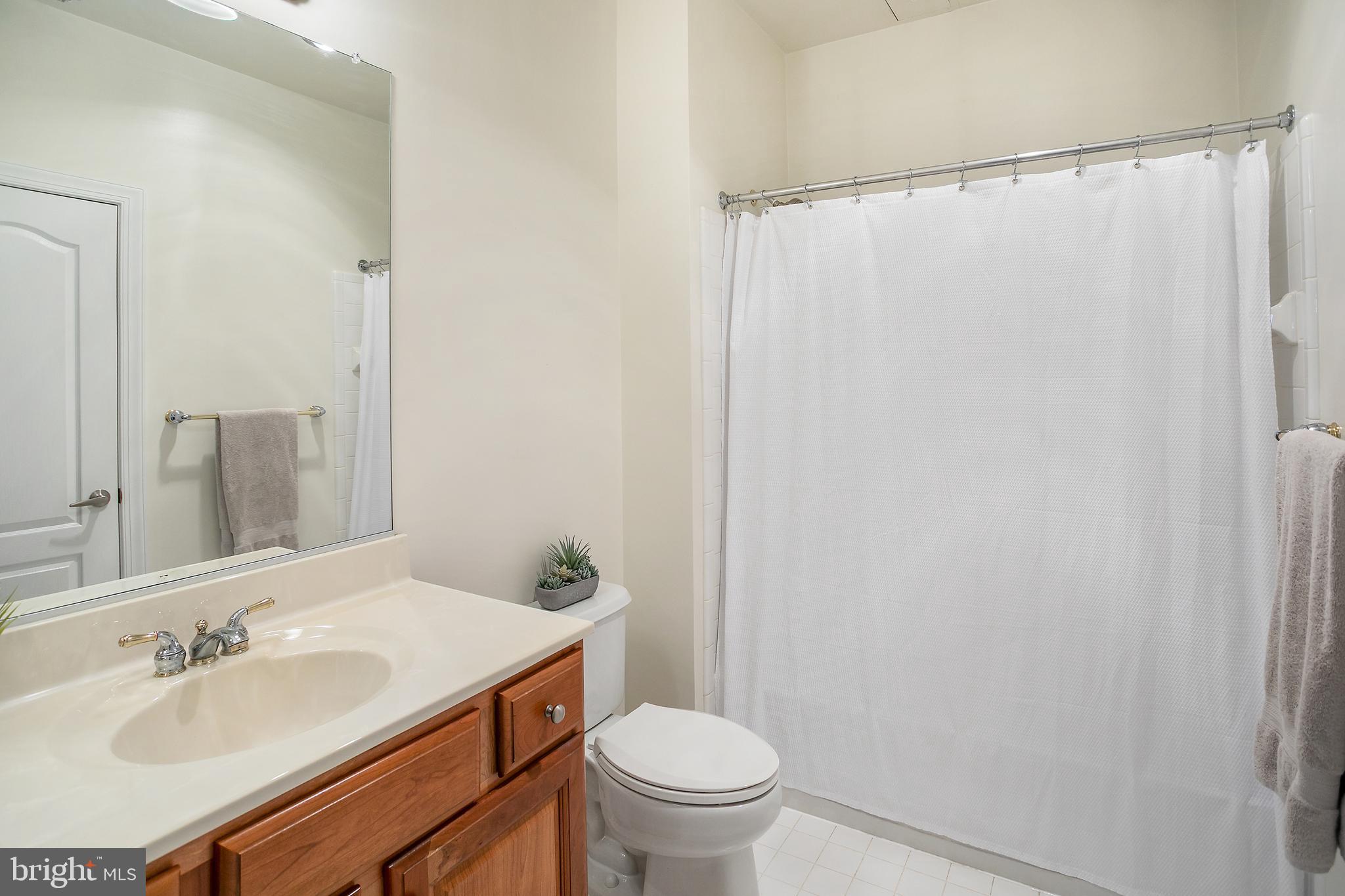 400 Cameron Station Boulevard, Unit 308 Alexandria, VA 22304 - Photo 19 of 46 a bathroom with a sink toilet and a mirror