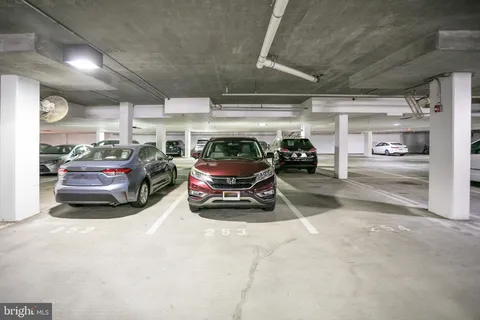 a view of parking garage with cars parked
