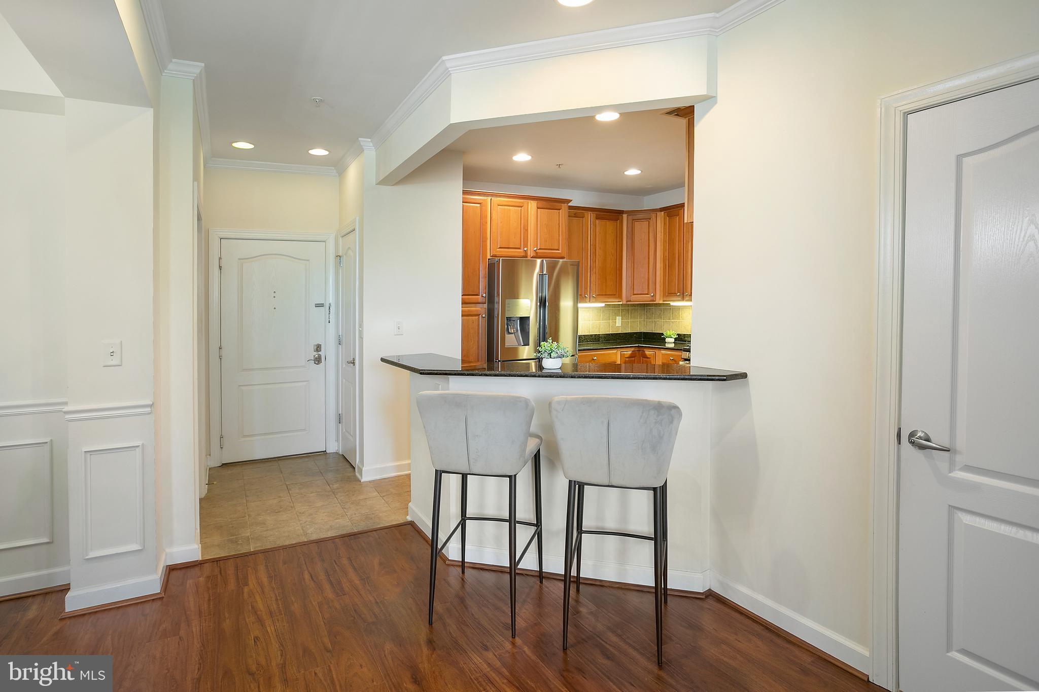 400 Cameron Station Boulevard, Unit 308 Alexandria, VA 22304 - Photo 4 of 46 a kitchen with a table and chairs in it