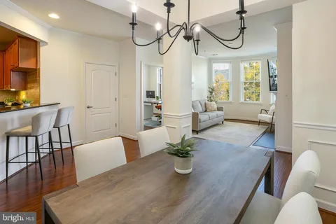 a living room with furniture dining table and a chandelier