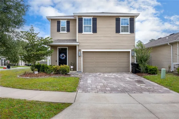 a front view of a house with a yard and garage