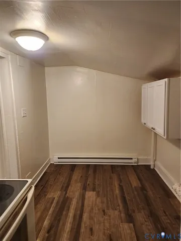 a view of room with wooden floor