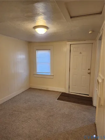 an empty room with windows and closet