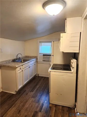 a kitchen with a sink a stove and cabinets