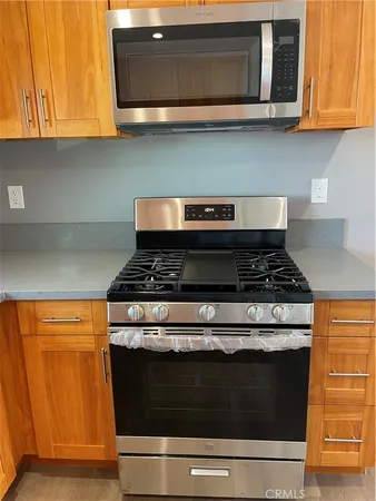 a stove top oven sitting inside of a kitchen