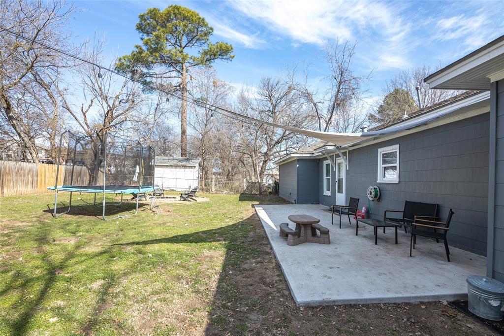 1308 Myrtle Street Denton, TX 76201 - Photo 11 of 35 a view of a backyard with table and chairs