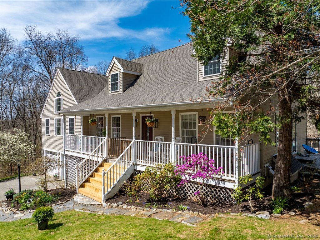 a view of a house with backyard and sitting area